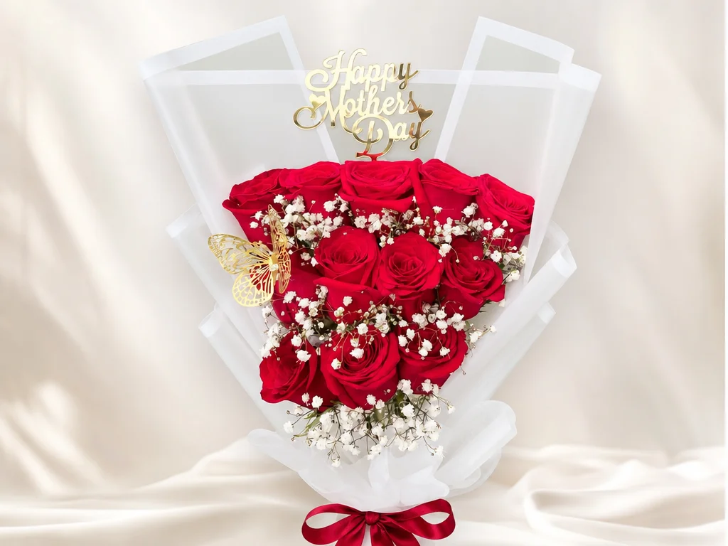 A dozen red roses with baby's breath in white wrap with a Happy Mother's Day gold topper