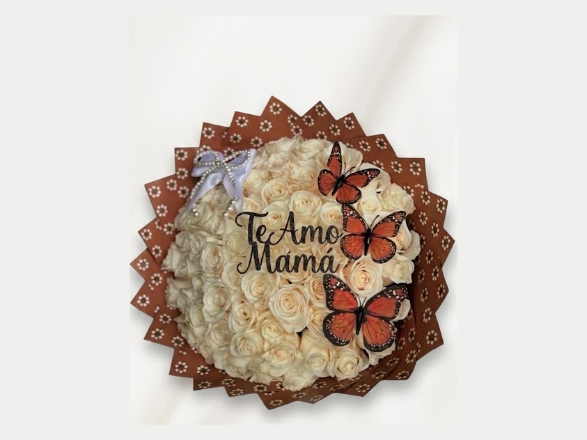 Dome of ivory roses in patterned brown wrap with orange monarch butterflies and a Te Amo Mama topper